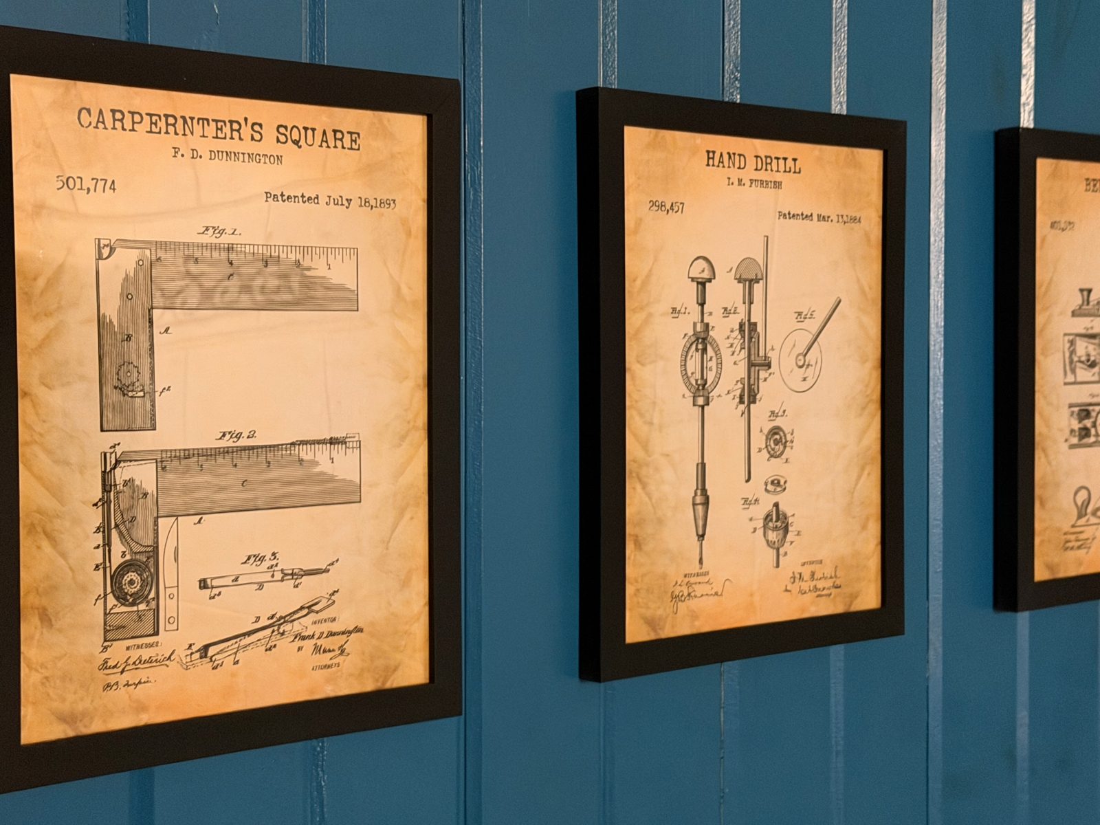The Architect’s Suite — framed vintage tool patent prints arranged on the accent wall