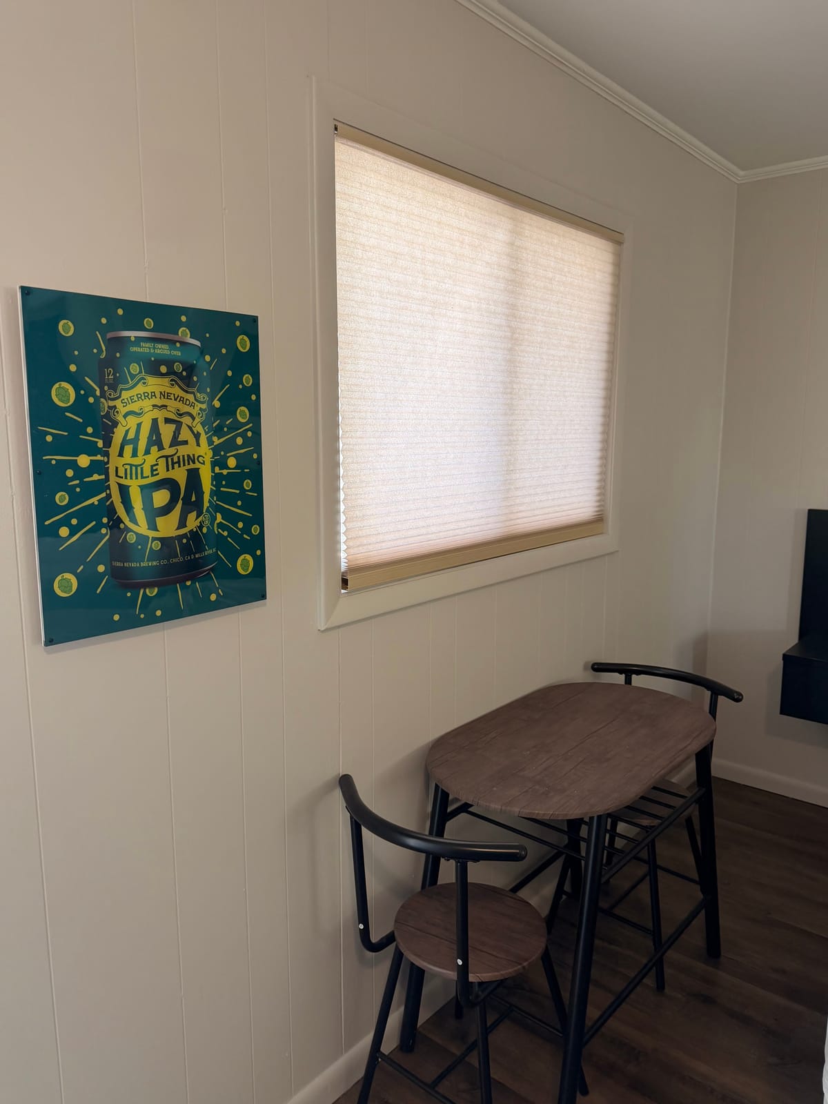 The Brewmaster's Room — Sierra Nevada Hazy Little Thing IPA art print beside a rustic bistro table with two black chairs