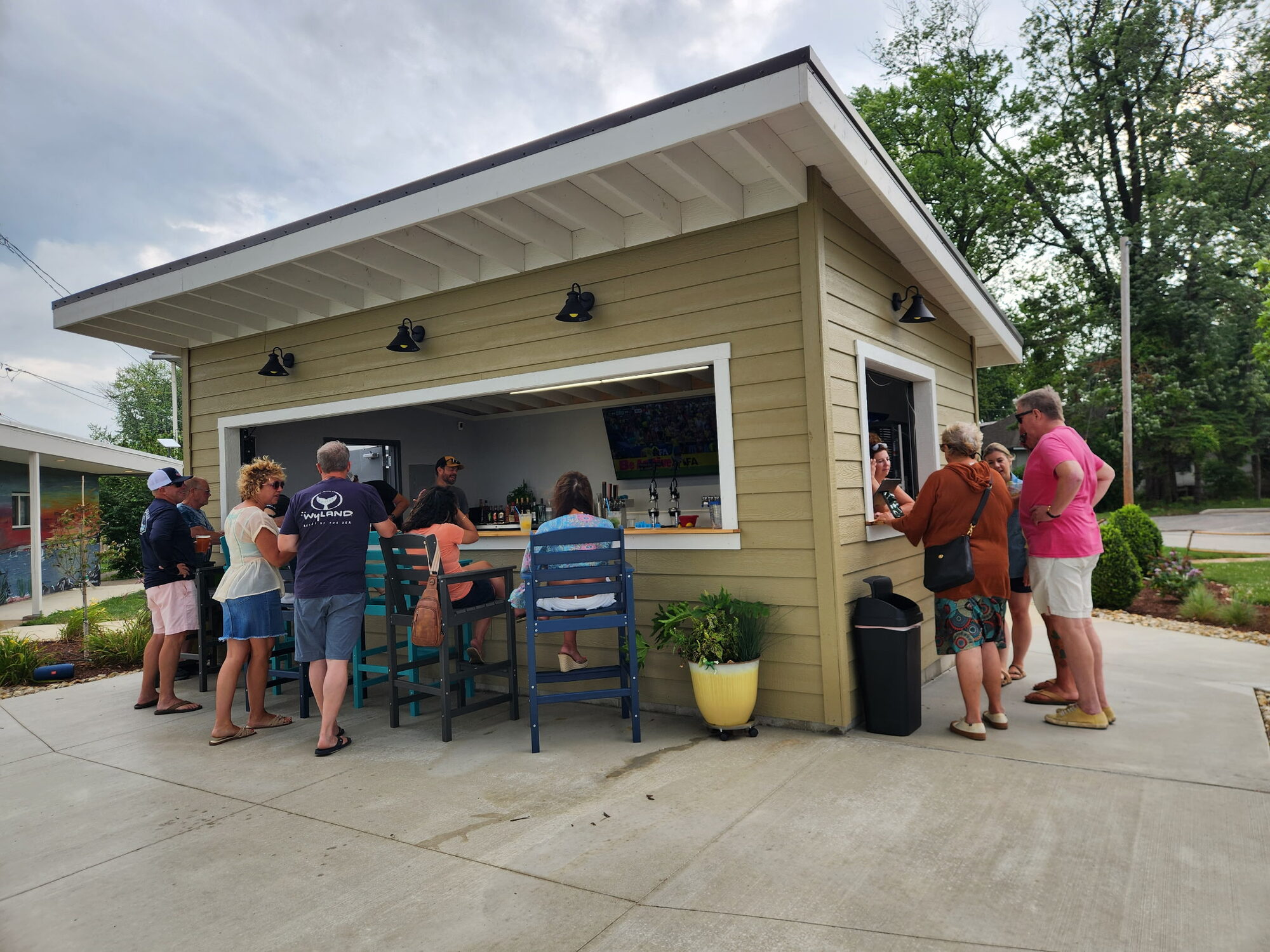 Guests at the walk-up bar at Tique's
